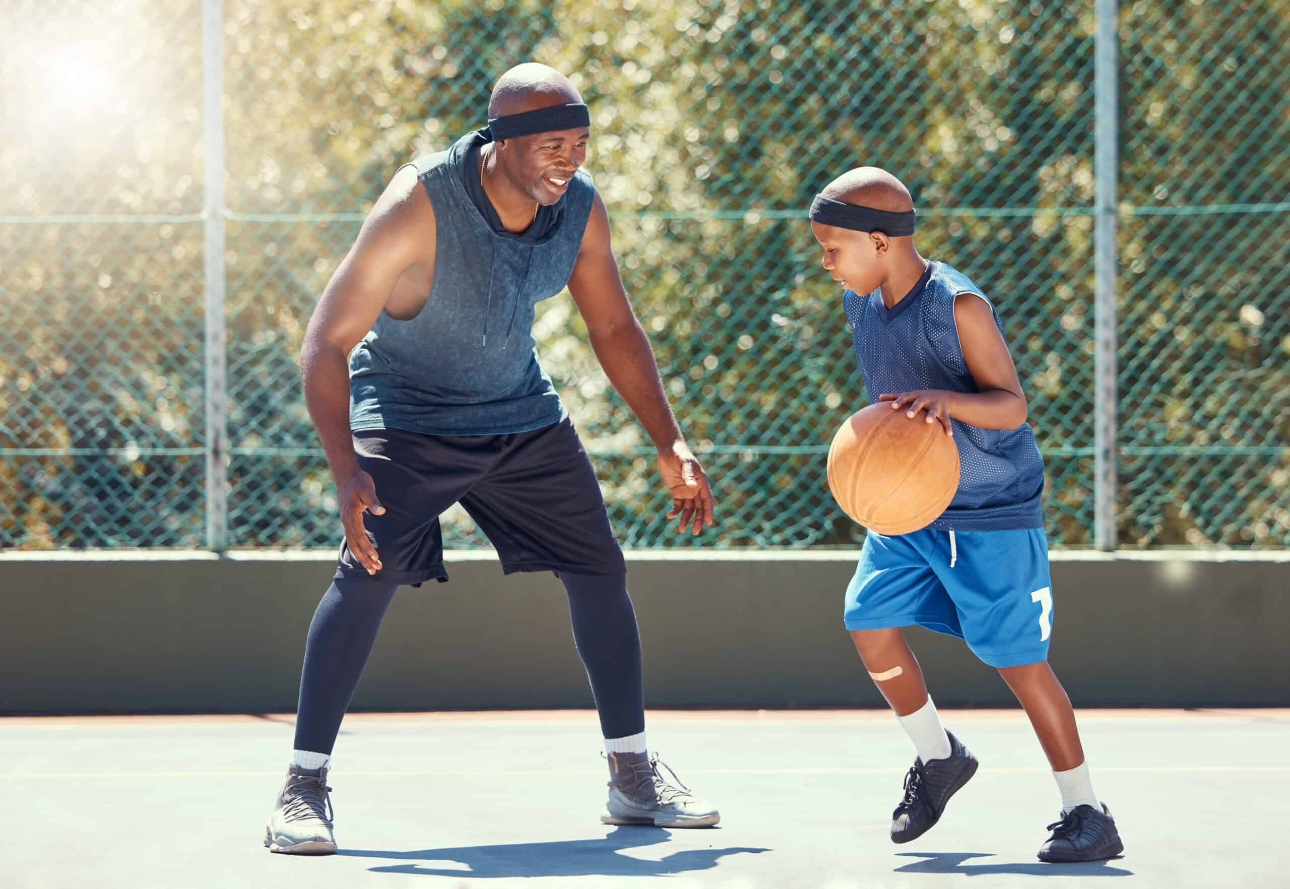 Youth playing basketball together as part of the GAME program.